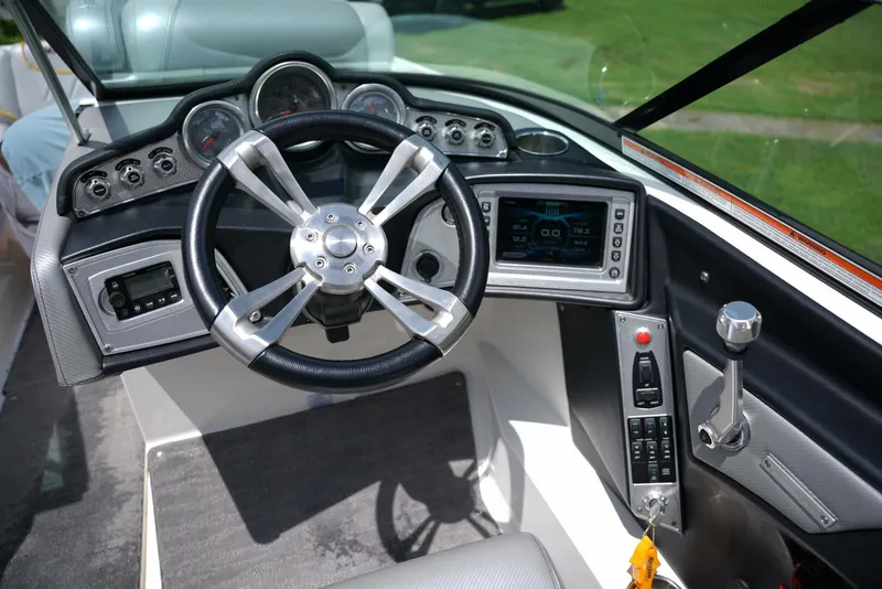 Slide: The Image of 2014 MasterCraft X-25 boat interior with gray seating and cup holders. - 24