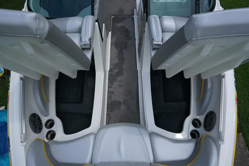 Slide: The Image of 2014 MasterCraft X-25 boat interior with open storage compartments and seating. - 29