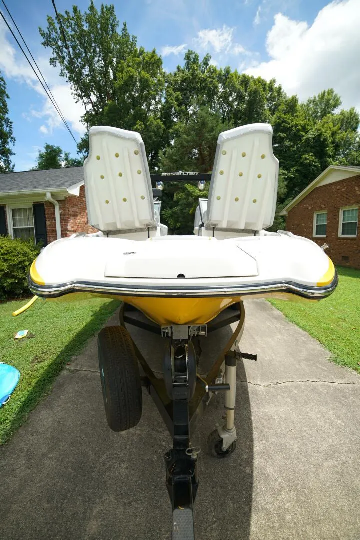 Slide: The Image of 2014 MasterCraft X-25 boat on trailer, parked in driveway, with lush greenery background. - 30