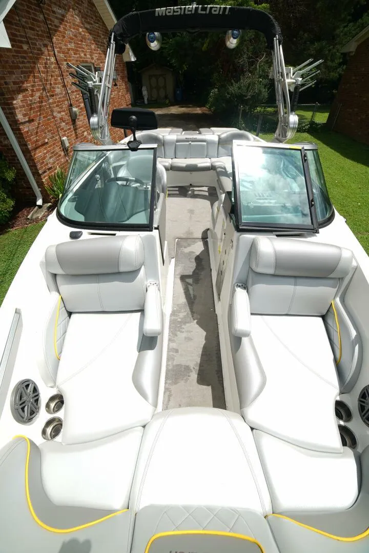 Slide: The Image of 2014 MasterCraft X-25 boat interior with white seating and modern design. - 42