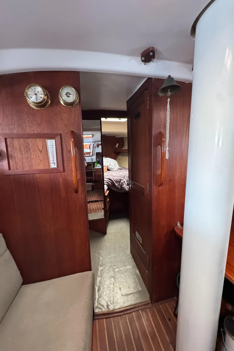 Slide: The Image of Interior of 1981 Morgan 416 Out Island sailboat with wooden paneling and cozy cabin. - 10