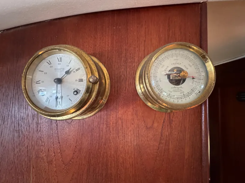 Slide: The Image of Brass clock and barometer on 1981 Morgan 416 Out Island yacht's wooden interior. - 11