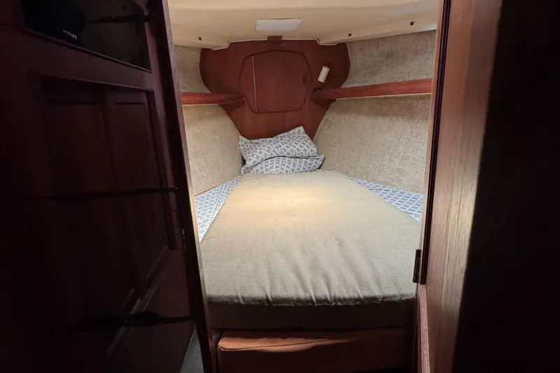 Slide: The Image of Cozy cabin interior of 1981 Morgan 416 Out Island sailboat with bed and wooden accents. - 12