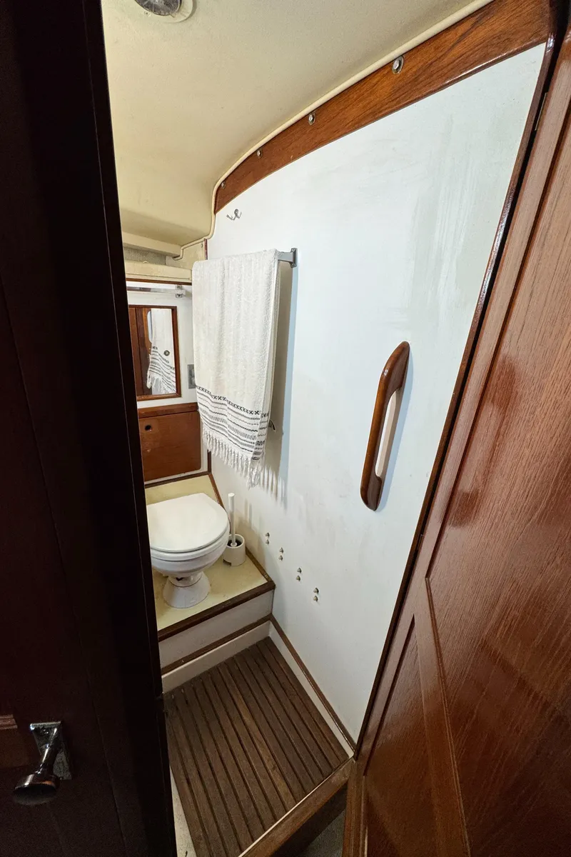 Slide: The Image of 1981 Morgan 416 Out Island yacht bathroom with wooden accents and towel rack. - 15