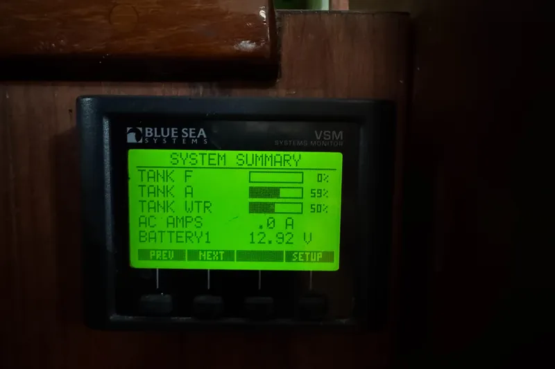 Slide: The Image of Blue Sea Systems monitor displaying tank levels and battery voltage on a 1981 Morgan 416 Out Island. - 18