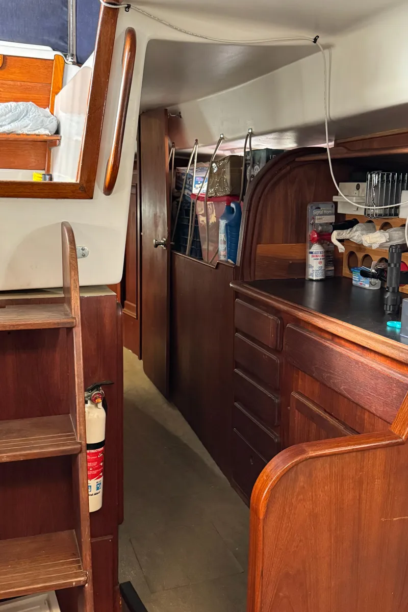 Slide: The Image of Interior of 1981 Morgan 416 Out Island sailboat with wooden cabinetry and storage. - 20