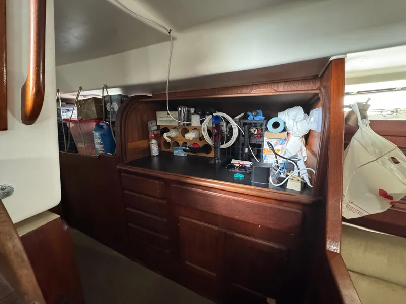 Slide: The Image of Interior of 1981 Morgan 416 Out Island sailboat with wooden cabinetry and storage. - 21