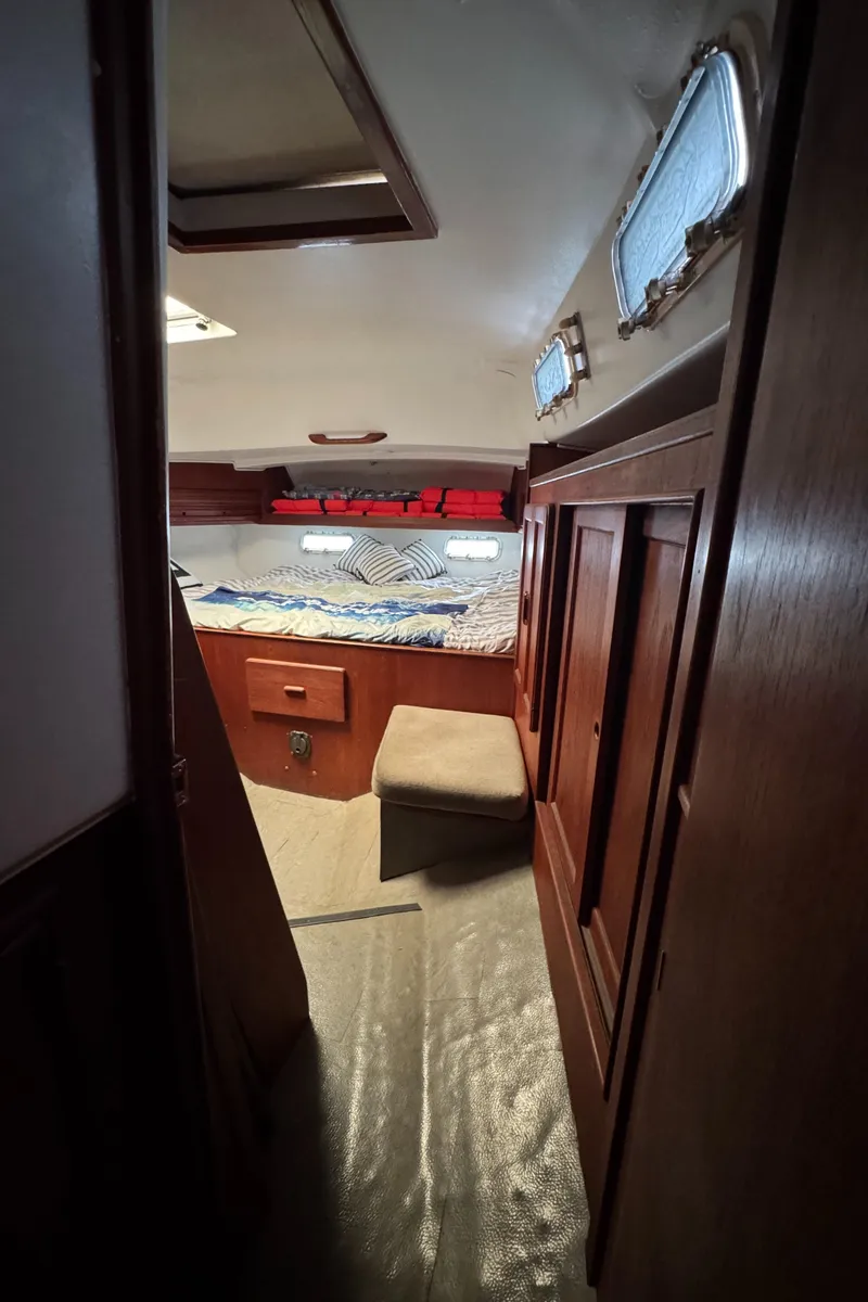 Slide: The Image of 1981 Morgan 416 Out Island cabin interior with cozy bed and wooden furnishings. - 24