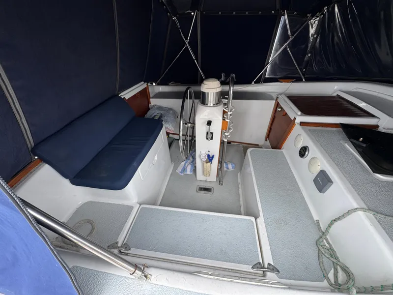 Slide: The Image of 1981 Morgan 416 Out Island sailboat cockpit with steering wheel and seating area. - 3