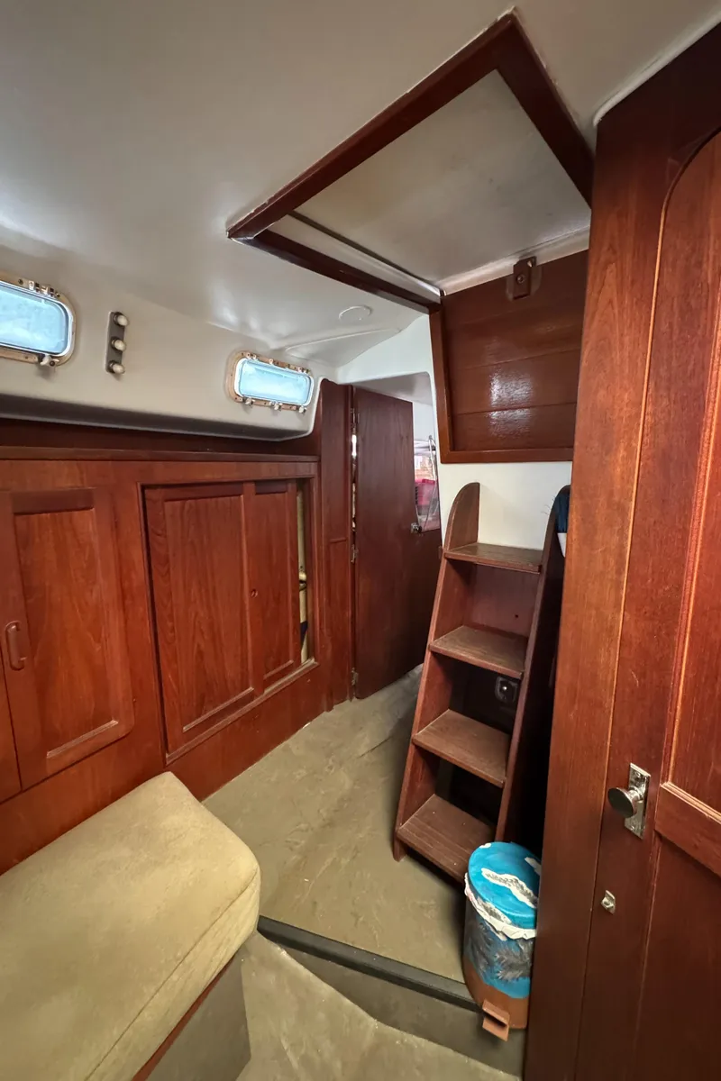 Slide: The Image of Interior of 1981 Morgan 416 Out Island sailboat with wooden cabinetry and ladder. - 32