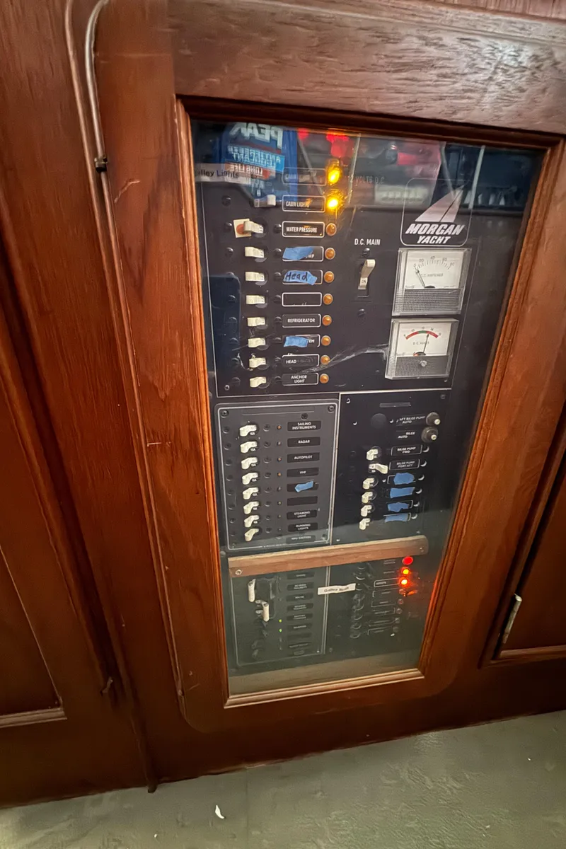 Slide: The Image of Electrical panel inside a 1981 Morgan 416 Out Island yacht, featuring switches and meters. - 33