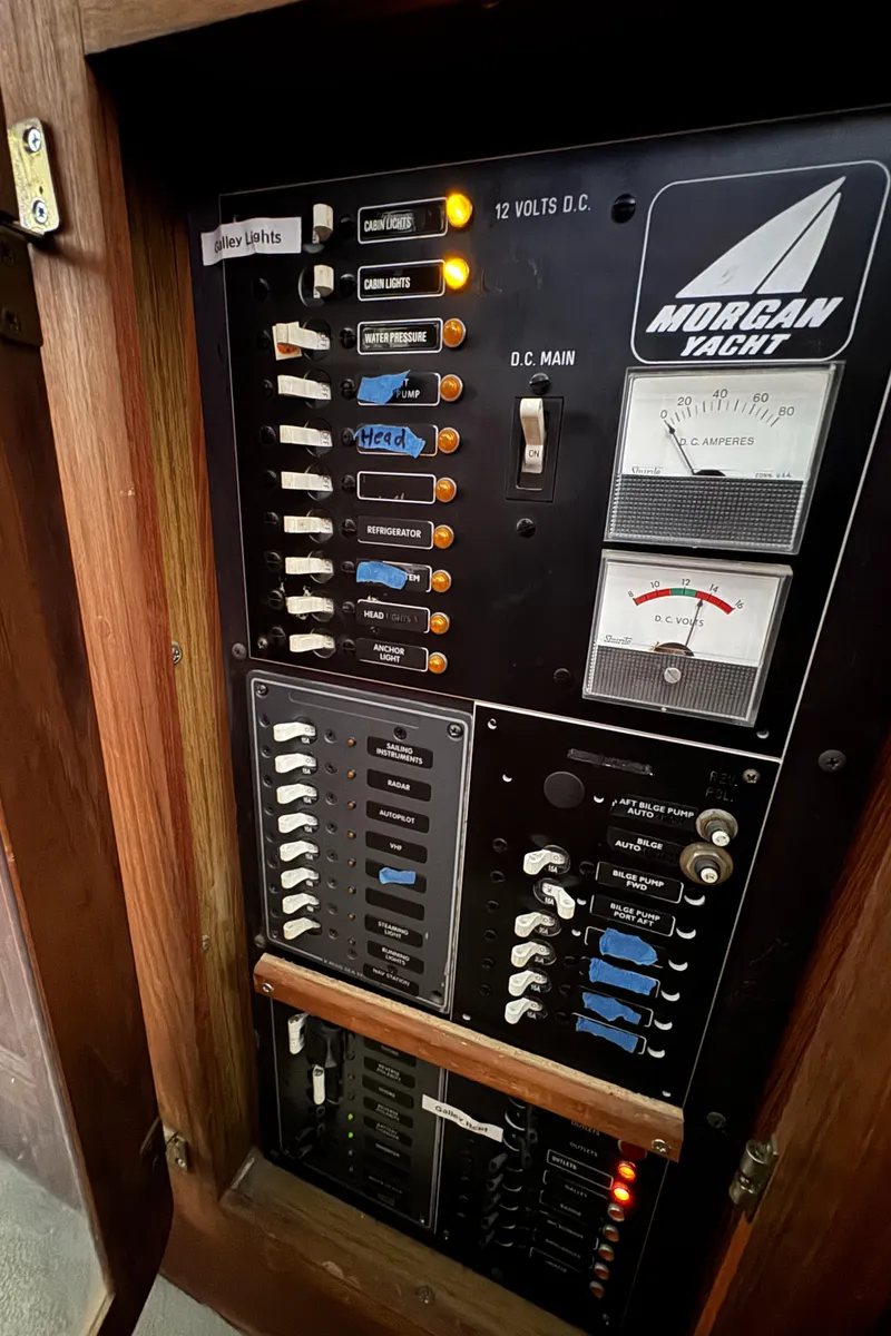 Slide: The Image of Electrical panel of a 1981 Morgan 416 Out Island yacht with labeled switches and gauges. - 34