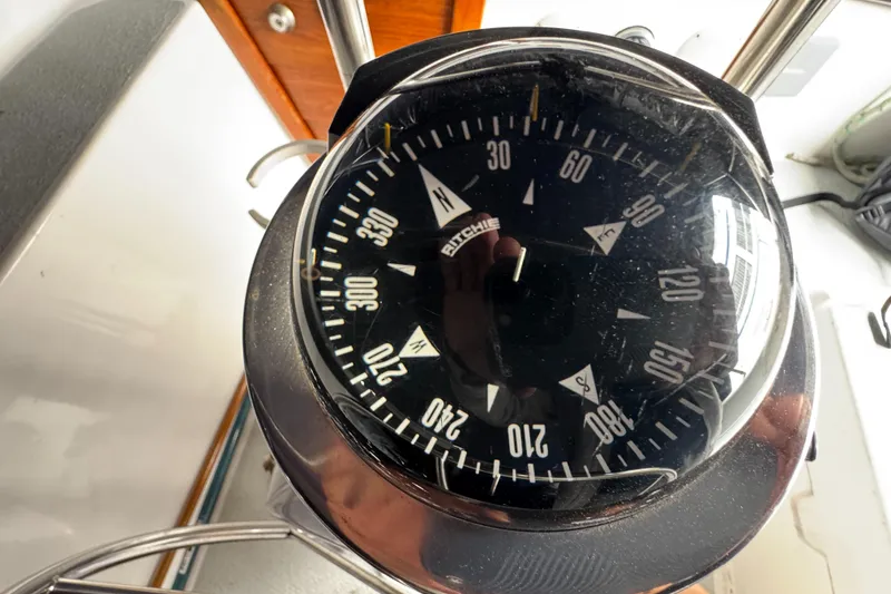 Slide: The Image of Compass on 1981 Morgan 416 Out Island sailboat, showing navigation directions. - 40