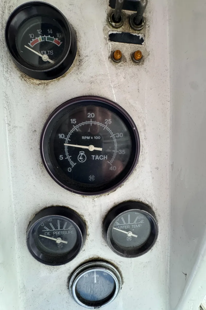 Slide: The Image of Dashboard gauges of a 1981 Morgan 416 Out Island sailboat, showing tachometer, voltmeter, and more. - 42