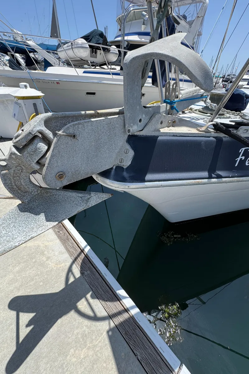Slide: The Image of 1981 Morgan 416 Out Island sailboat with large anchor at marina dock. - 45