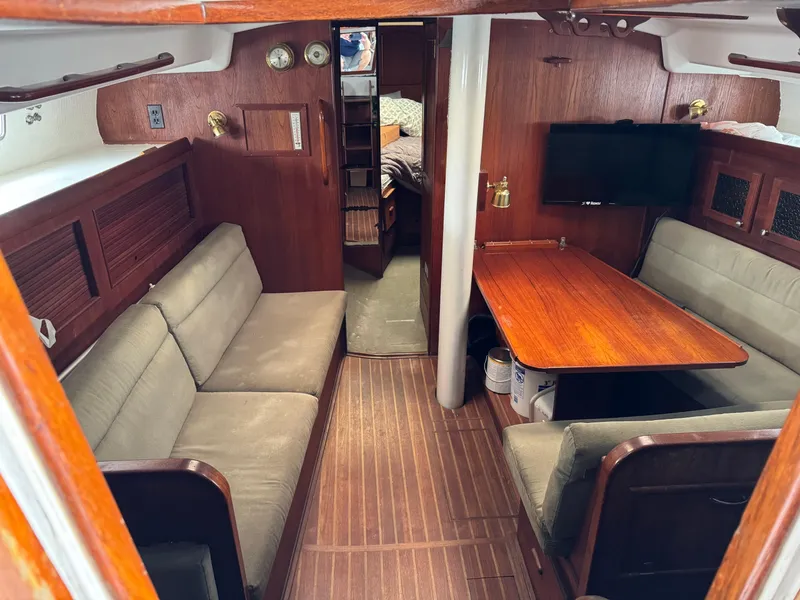 Slide: The Image of Interior of 1981 Morgan 416 Out Island sailboat with wood paneling and seating area. - 5
