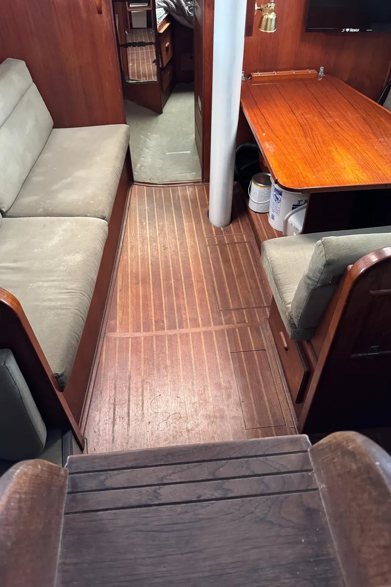 Slide: The Image of Interior of 1981 Morgan 416 Out Island sailboat with wooden flooring and seating area. - 6