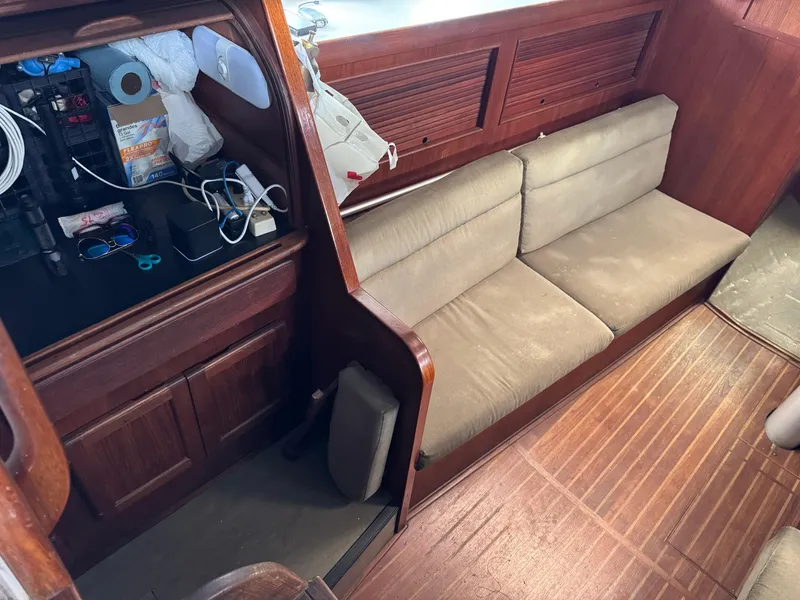 Slide: The Image of Interior of 1981 Morgan 416 Out Island sailboat with wooden finish and beige seating. - 7