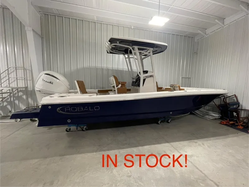 The Image of 2025 Robalo 246 Cayman boat in stock, displayed in a showroom. - 1