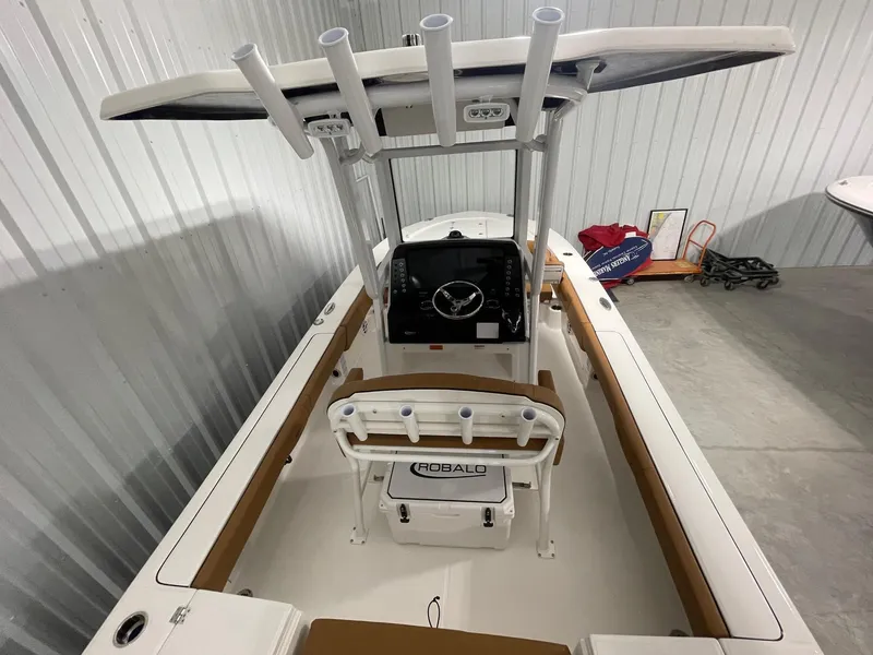 Slide: The Image of 2025 Robalo 246 Cayman boat interior with helm and seating in a storage area. - 5
