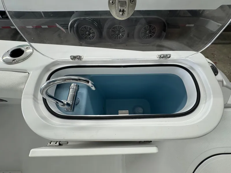 Slide: The Image of Livewell compartment on 2025 Wellcraft 243 Fisherman boat, featuring a sleek faucet design. - 11