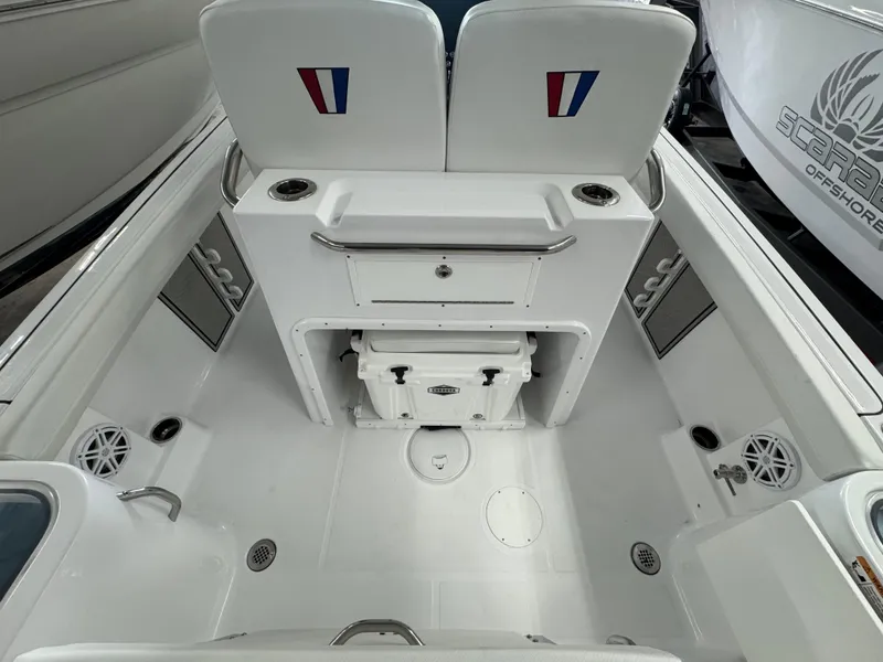 Slide: The Image of 2025 Wellcraft 243 Fisherman boat interior with seating, storage, and cup holders. - 12