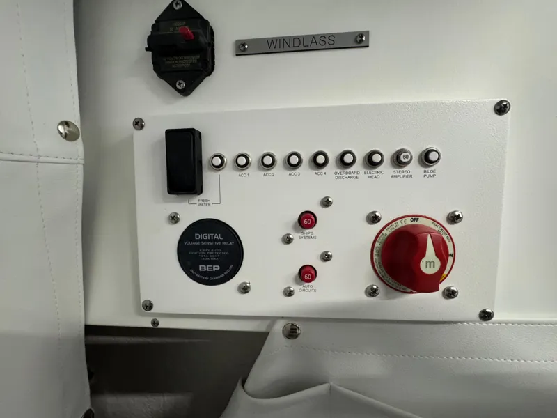 Slide: The Image of Control panel of 2025 Wellcraft 243 Fisherman boat, featuring switches and digital relay. - 16