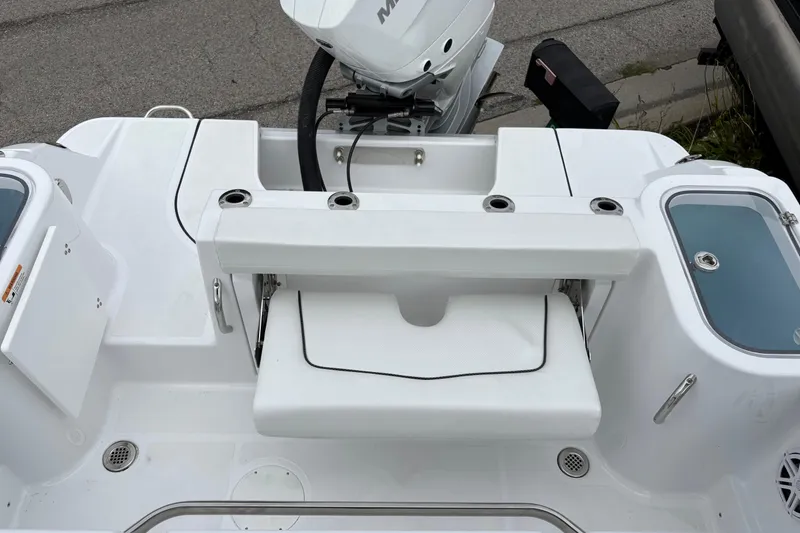 Slide: The Image of 2025 Wellcraft 243 Fisherman boat interior with seating and motor, showcasing modern design. - 18