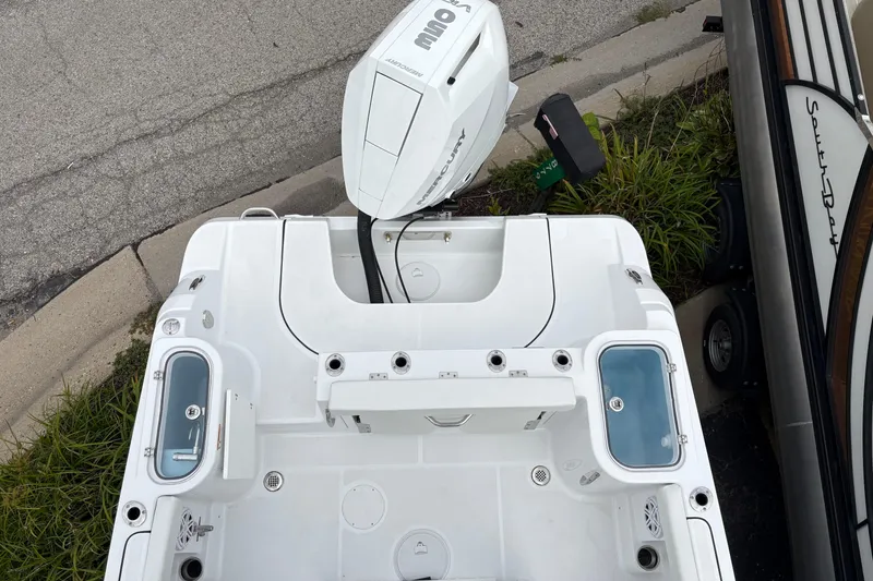 Slide: The Image of 2025 Wellcraft 243 Fisherman boat with outboard motor, viewed from above, parked on a street. - 19