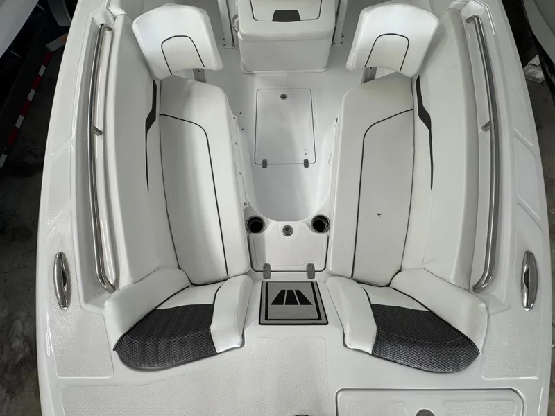 Slide: The Image of 2025 Wellcraft 243 Fisherman boat interior with white seating and storage compartments. - 6