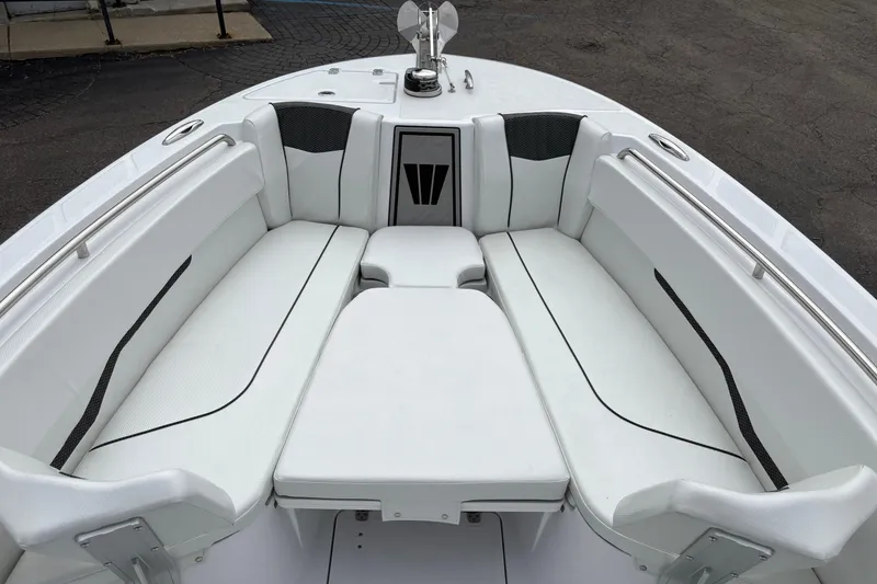 Slide: The Image of 2025 Wellcraft 243 Fisherman boat interior with white cushioned seating. - 7