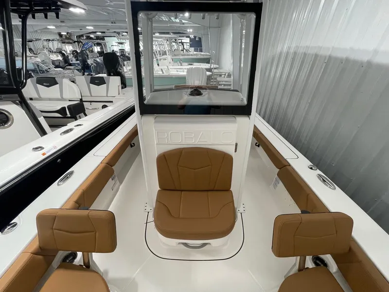 Slide: The Image of 2025 Robalo 246 Cayman boat interior with brown seating and sleek design. - 11