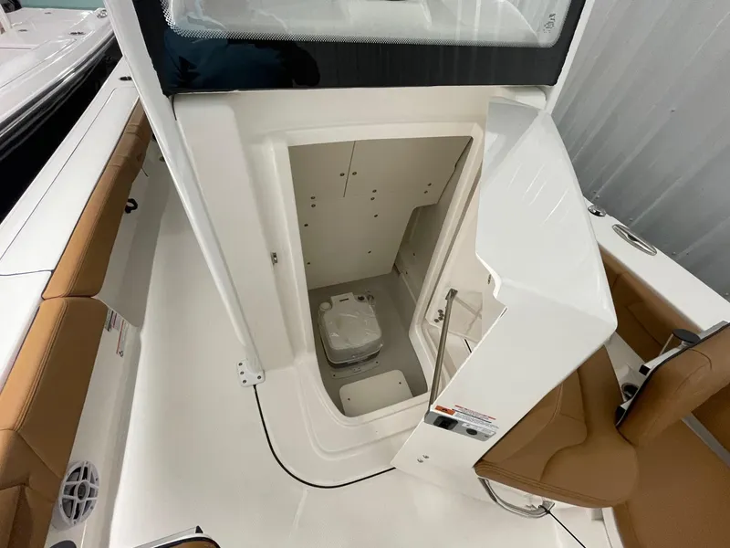 Slide: The Image of 2025 Robalo 246 Cayman boat interior with open storage compartment and seating. - 12