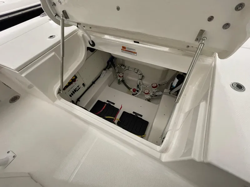 Slide: The Image of Open storage compartment of 2025 Robalo 246 Cayman boat, showcasing interior components. - 14