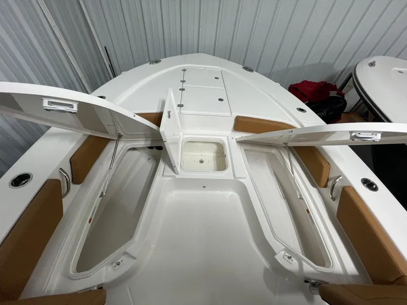Slide: The Image of 2025 Robalo 246 Cayman boat interior with open storage compartments. - 3