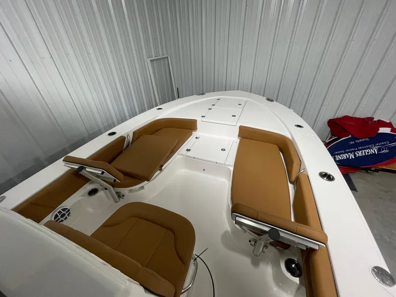 Slide: The Image of 2025 Robalo 246 Cayman boat interior with tan seating and white deck. - 7