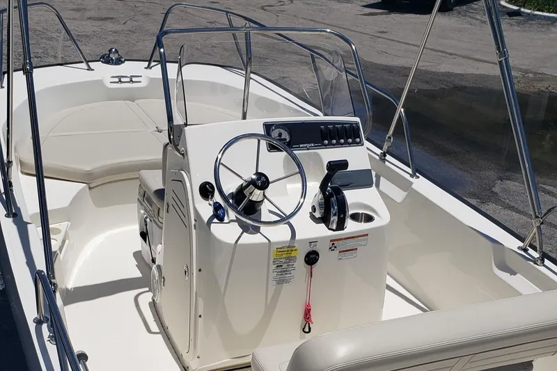 Slide: The Image of 2022 Boston Whaler 170 Montauk boat interior with steering console and seating. - 29