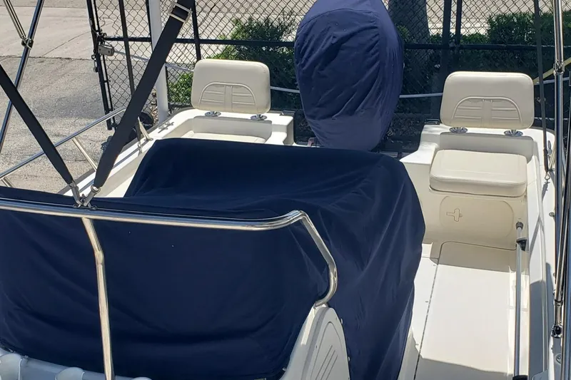 Slide: The Image of 2022 Boston Whaler 170 Montauk boat interior with blue covers and white seating. - 38