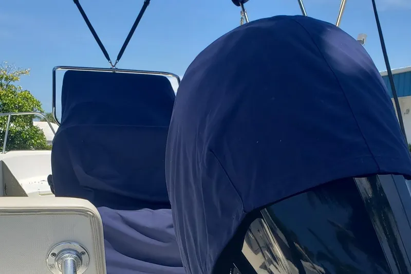 Slide: The Image of 2022 Boston Whaler 170 Montauk boat with blue covers, sunny day. - 39