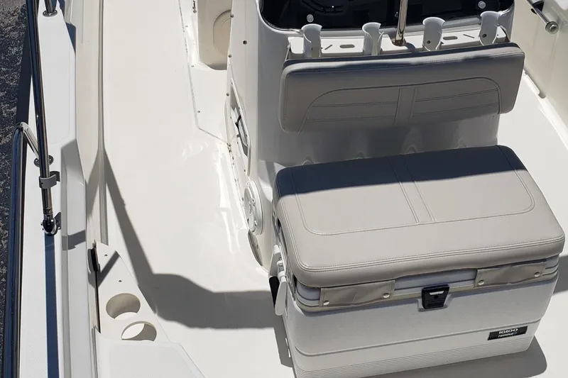 Slide: The Image of 2022 Boston Whaler 170 Montauk boat interior with cushioned seating and storage. - 43