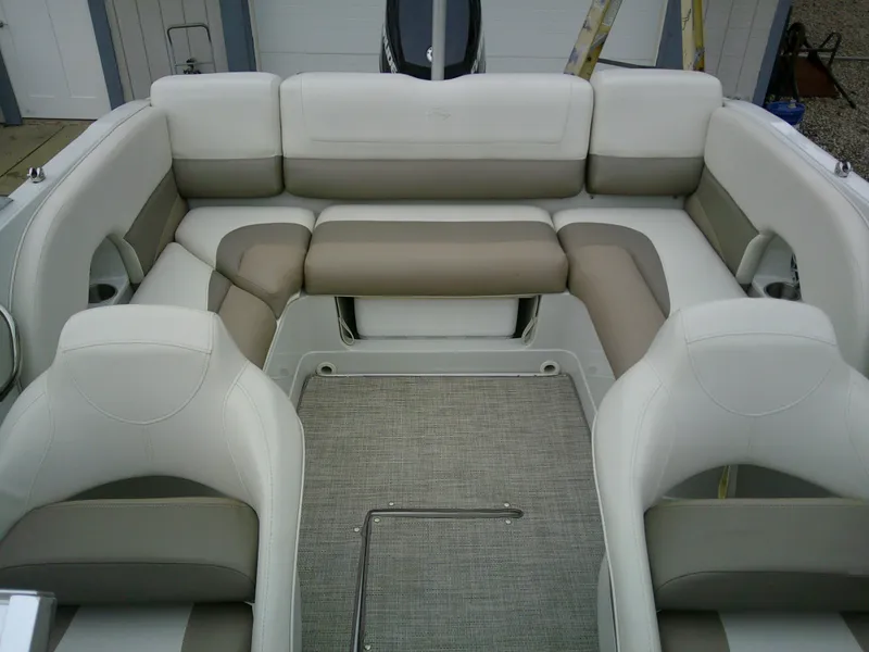 Slide: The Image of 2019 Crownline 19 XS boat interior with beige seating and cup holders. - 11