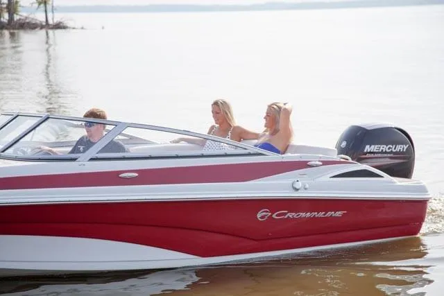 Slide: The Image of 2019 Crownline 19 XS boat with Evinrude outboard motor, parked on a trailer. - 3