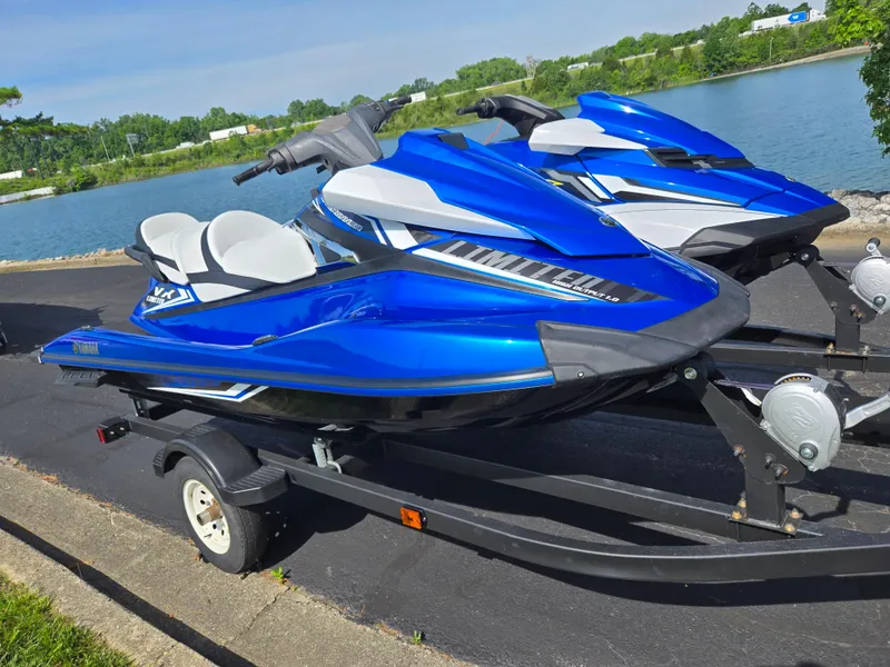 Slide: The Image of 2017 Yamaha WaveRunner VX Limited jet skis on trailer by a lake. - 8