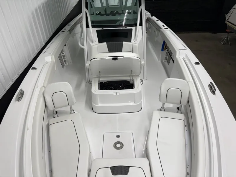 Slide: The Image of 2025 Wellcraft 352 Fisherman boat interior with white seating and storage compartments. - 6