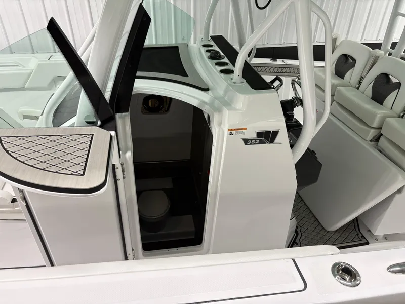 Slide: The Image of 2025 Wellcraft 352 Fisherman boat interior with seating and helm station. - 8