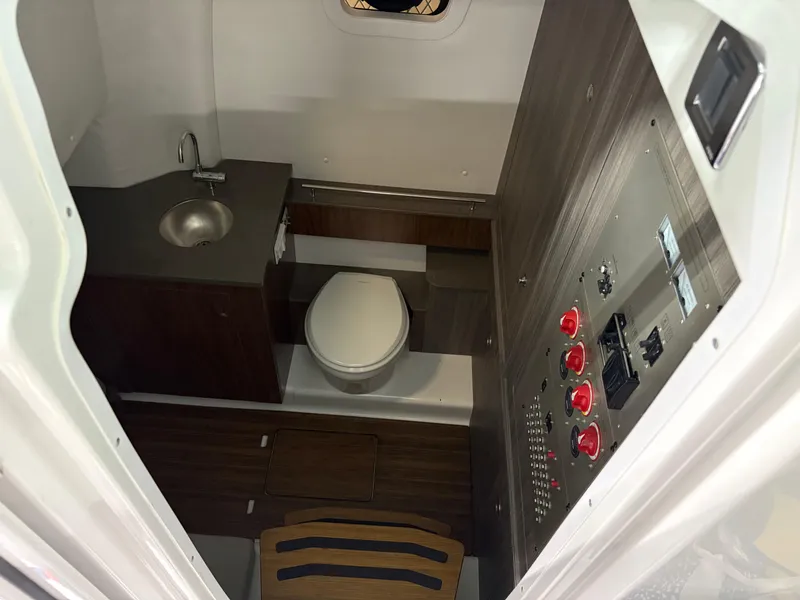 Slide: The Image of 2025 Wellcraft 352 Fisherman boat interior with sink, toilet, and control panel. - 9