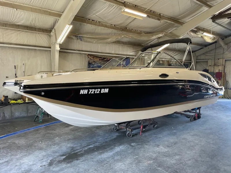 The Image of 2014 Starcraft Crossover 250 SCX IO boat in indoor storage facility. - 0