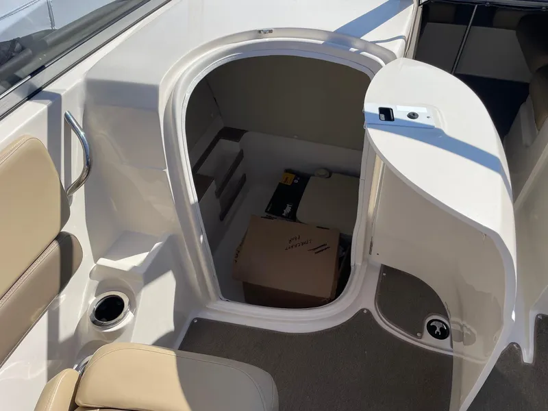 Slide: The Image of 2014 Starcraft Crossover 250 SCX IO boat interior with open storage compartment. - 3