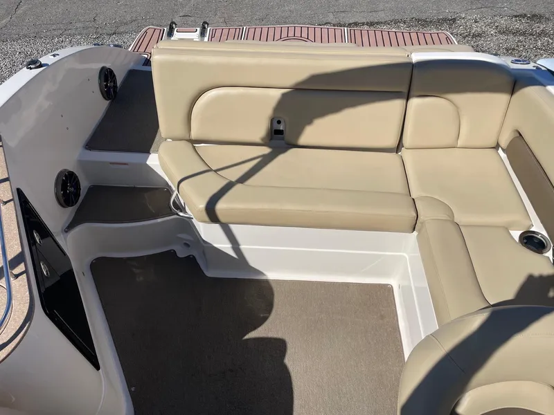 Slide: The Image of 2014 Starcraft Crossover 250 SCX IO boat interior with beige seating and carpeted floor. - 4