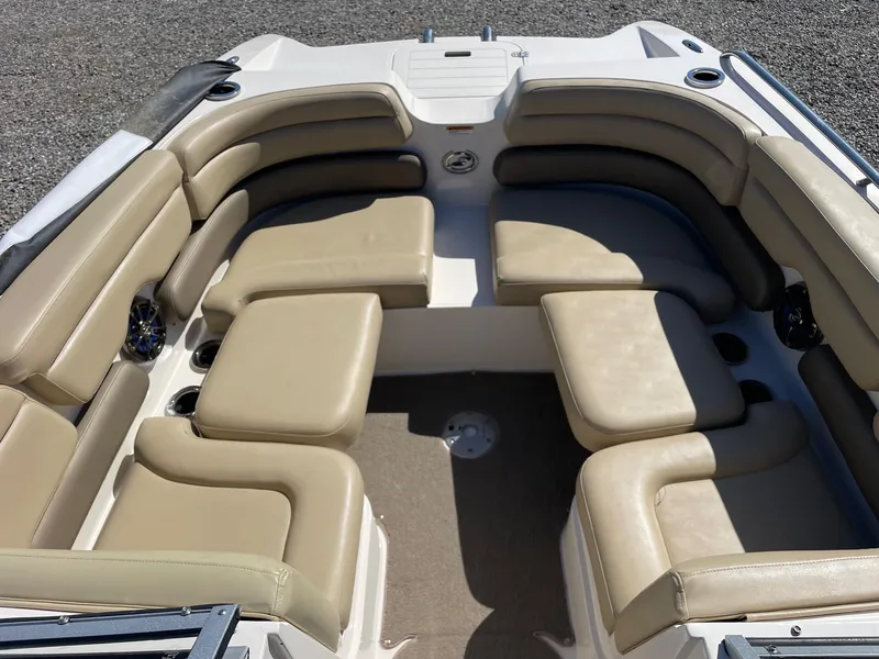 Slide: The Image of 2014 Starcraft Crossover 250 SCX IO boat interior with beige seating and cup holders. - 5